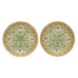 Pair of Chinese famille rose porcelain saucer dishes, each enamelled on a yellow ground with the