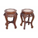 Pair of Chinese hardwood jardinière stands, each inset with marble tops over pierced pruns blossom