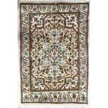Small Kashmir pattern rug, with a central floral medallion on a natural ground, 40" x 25" approx