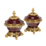 Pair of French ormolu mounted lacquered papier maché pot pourri urns with pierced covers, raised