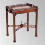 Chippendale style mahogany serpentine tray on stand, the tray with a pierced fret twin handled