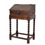 17th century and later oak table writing box, with sloped hinged cover enclosing an open interior