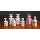 Set of five French porcelain scent bottles with stoppers, decorated with floral sprays within pink