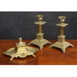 Pair of Aesthetic brass candlesticks, with Corinthian column supports over squared bases raised on