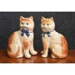 Pair of similar Staffordshire pottery cat figures, 7.5" high