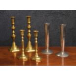 Three pairs of candlesticks, to include two brass pairs and a planished chrome pair, the tallest 10"