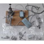 Small electric clock/watchmakers lathe with various attachments and accessories, mounted onto a