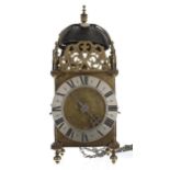 19th century English brass hook and spike lantern clock, the foliate engraved dial signed Thos.