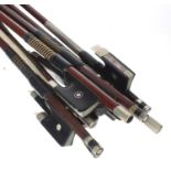 Nine various nickel mounted violin bows, some stamped (9)