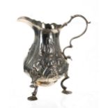 George II silver cream jug, with a card cut rim and C scroll capped handle over a pear shape
