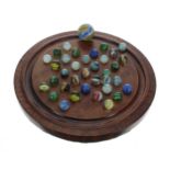 Rosewood marble solitaire board, 9.5" diameter; together with a selection of vintage glass marbles