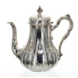 Victorian silver coffee pot, the hinged cover with cast finial, with a scroll handle and shaped