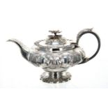 George IV squat silver teapot, the hinged cover with a cast foliate finial, with a foliate capped