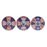 Three similar Japanese Imari fluted porcelain wall chargers, each with foliate designs in typical