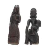 Two Southern Indian carved treen figures of ladies, one sat with a child on her knee, the other