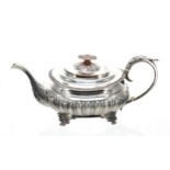 George IV silver teapot, the hinged cover with a cast finial, and with a leaf capped handle with