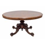 Victorian walnut oval breakfast table, the quarter veneer mounded tilt top, raised on a carved