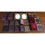 Group of sixteen leather daguerreotype frames/case, each with metal oval or arched aperture behind