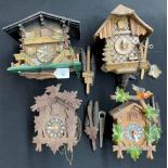 Four German carved treen cuckoo wall clocks, each with pendulums and each with two weights (4)