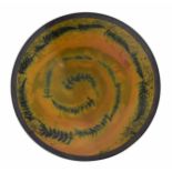 Andrew Hill (b.1964) studio pottery circular charger with spiral fern leaf decoration, with the
