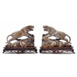 Pair of decorative Chinese carved stone figures of tigers, each modelled on naturalistic rocky