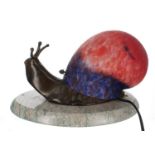 Bronze figural snail table lamp, with a mottled coloured glass shell form shade, mounted upon a