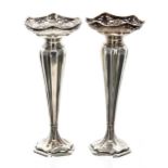 Pair of Henry Clifford Davis silver bud vases, with pierced bowls raised on baluster bodies over