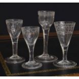 Group of four 18th century wine glasses, all with etched border decoration to the bowls over plain