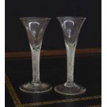 Two very similar Georgian cordial / wine glasses, each with trumpet bowls raised on multi spiral air