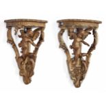 Two similar decorative gilt wood and gesso corner shelves, the figural supports of putti among