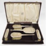 Boxed silver engine turned dressing table set, comprising a hand mirror, four brushes and comb