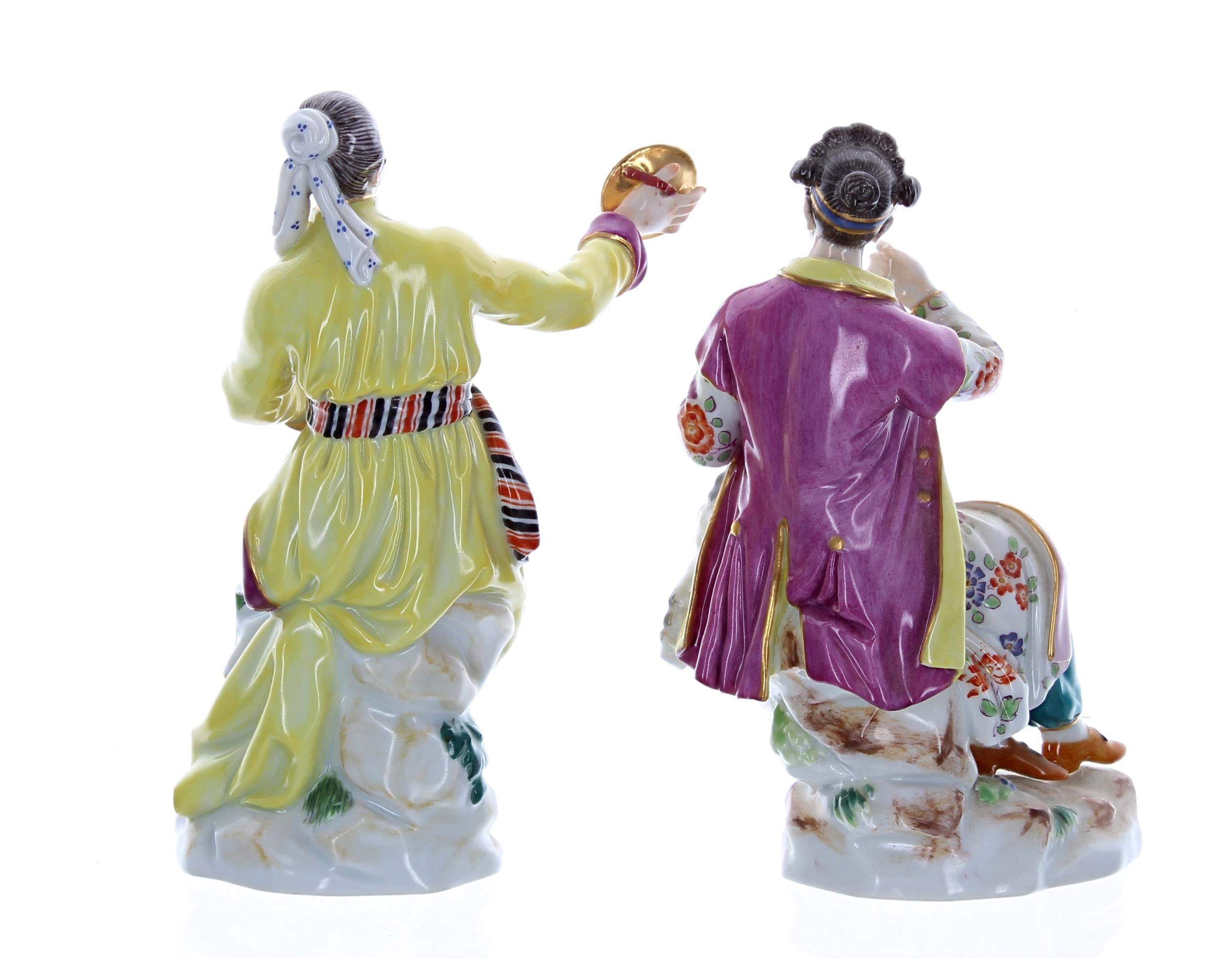 Two Meissen porcelain figures, a lady with cymbals and a lady with her dog on her lap, both - Image 2 of 3