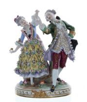 Sitzendorf porcelain figural group of a dancing couple, the lady holding a fan, a tree trunk behind,