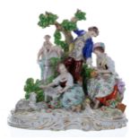 Sitzendorf porcelain figural group, modelled with a gentleman in a blue coat standing by a tree, a