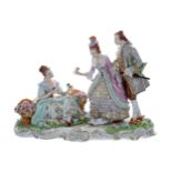 Sitzendorf porcelain figural group of a flower seller, with baskets at her side, with a lady and