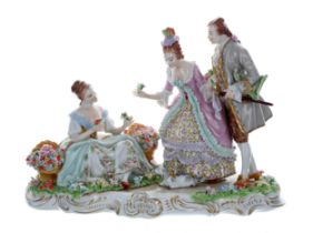 Sitzendorf porcelain figural group of a flower seller, with baskets at her side, with a lady and