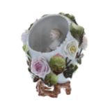 Sitzendorf ovoid porcelain vase, modelled as an egg with a figure of a lady seated inside with a