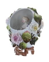 Sitzendorf ovoid porcelain vase, modelled as an egg with a figure of a lady seated inside with a