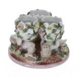 Sitzendorf porcelain centrepiece, modelled as three broken eggs supported by three cherub figures,