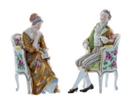 Pair of Dresden Potschappel porcelain figures, modelled as a lady in a gold dress seated on a floral