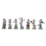 Set of seven Sitzendorf porcelain cherub band figures, playing various musical instruments,