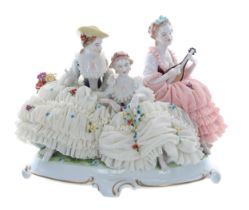 Unterweissbach porcelain figural group of three ladies in simulated net dresses encrusted with