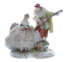 Unterweissbach porcelain figural group of a seated lady in a simulated net crinoline dress, a