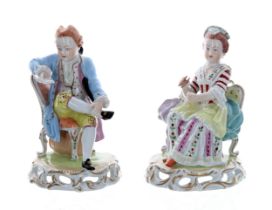 Pair of Dresden Potschappel porcelain figures, of a gentleman in a pale blue coat seated while