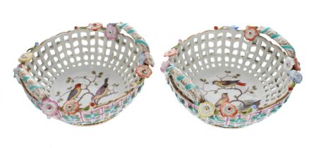 Pair of Dresden twin-handled porcelain baskets, with painted bird decoration to the interior