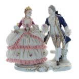 Unterweissbach porcelain figural group of a lady wearing a simulated net crinoline dress with a