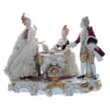 Unterweissbach porcelain figural group interior scene, modelled with a lady in a simulated net dress