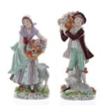 Pair of Sitzendorf porcelain figures; a man carrying a basket of flowers on his shoulder with a