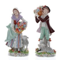 Pair of Sitzendorf porcelain figures; a man carrying a basket of flowers on his shoulder with a