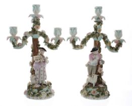 Pair of late 19th century German porcelain three-branch candelabra, the candle arms encrusted with